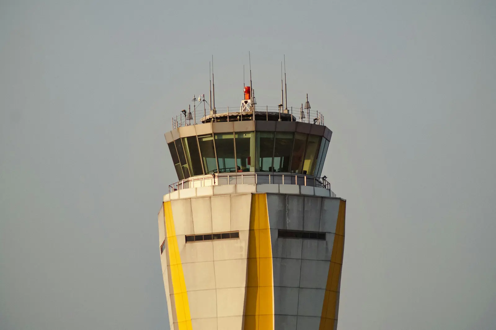 The glass cab of a control tower, seen from below.
